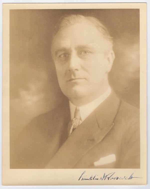 Item #57745 Portrait photograph of Franklin Delano Roosevelt, 32nd President of the United States (1933-1945), as Governor of New York (1929-1932), showing him looking straight ahead, slightly over his left shoulder, in suit jacket and silk tie, pocket handkerchief showing, his bold signature in the lower margin. Franklin Delano Bachrach ROOSEVELT, Sr, Louis Fabian, 32nd President of the United States.