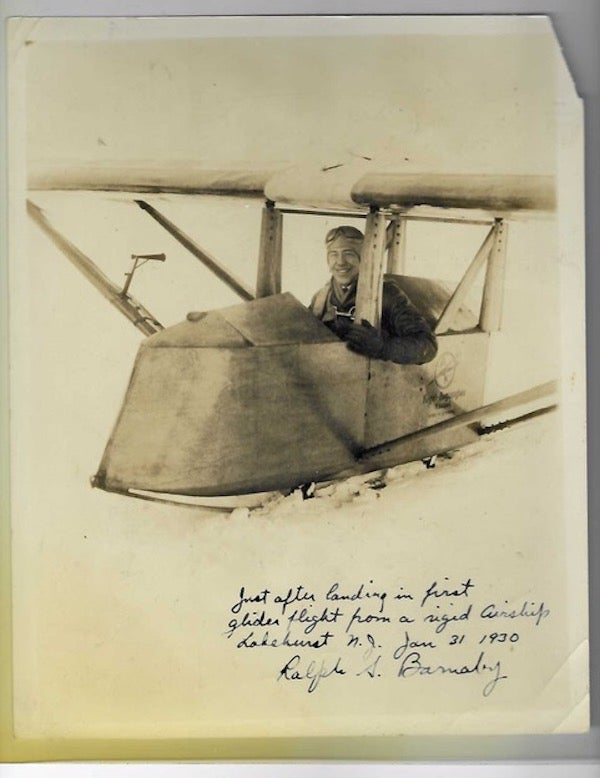 Item #59417 black and white photo of Ralph S. Barnaby in the cockpit of a glider, inscribed by him below the image "Just after landing in first / glider flight from a rigid airship / Lakehurst, N.J. Jan. 31, 1930 / Ralph S. Burnaby." Ralph S. Barnaby.