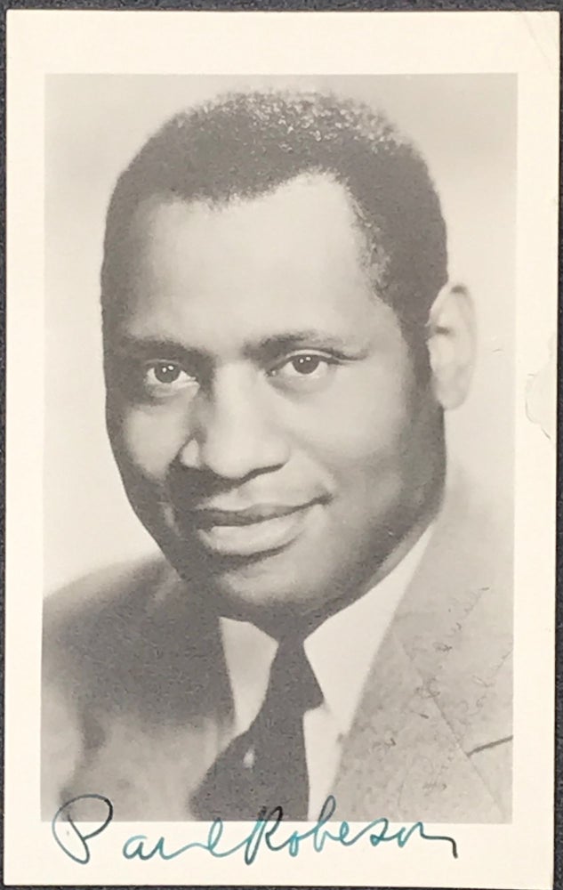 Item #63012 Real-photograph portrait postcard, 5 1/2 x 3 1/2 inches, signed in green ink in the lower margin, with portions of several letters of the signature entering the image. singer African-American athlete, actor, Civil Rights activist.